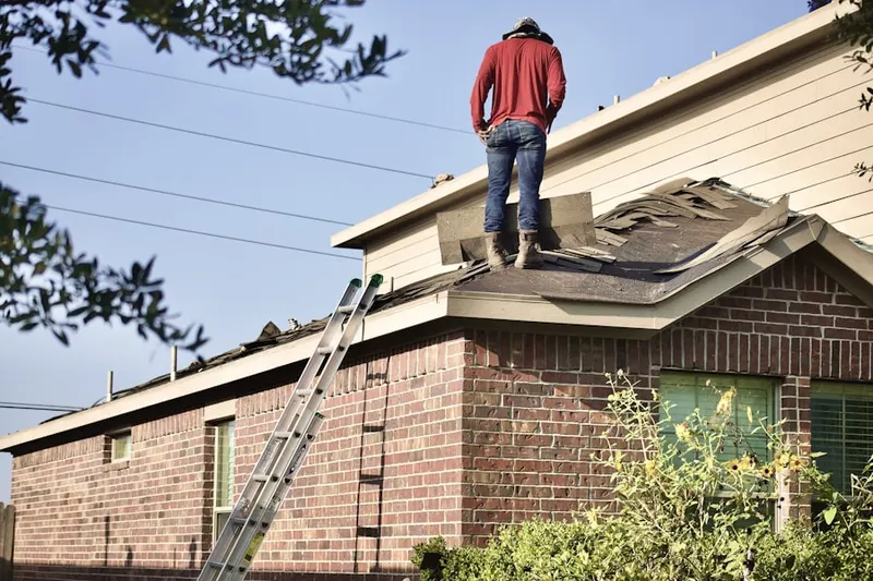 Professional roofer working on a residential roof in Wilshire